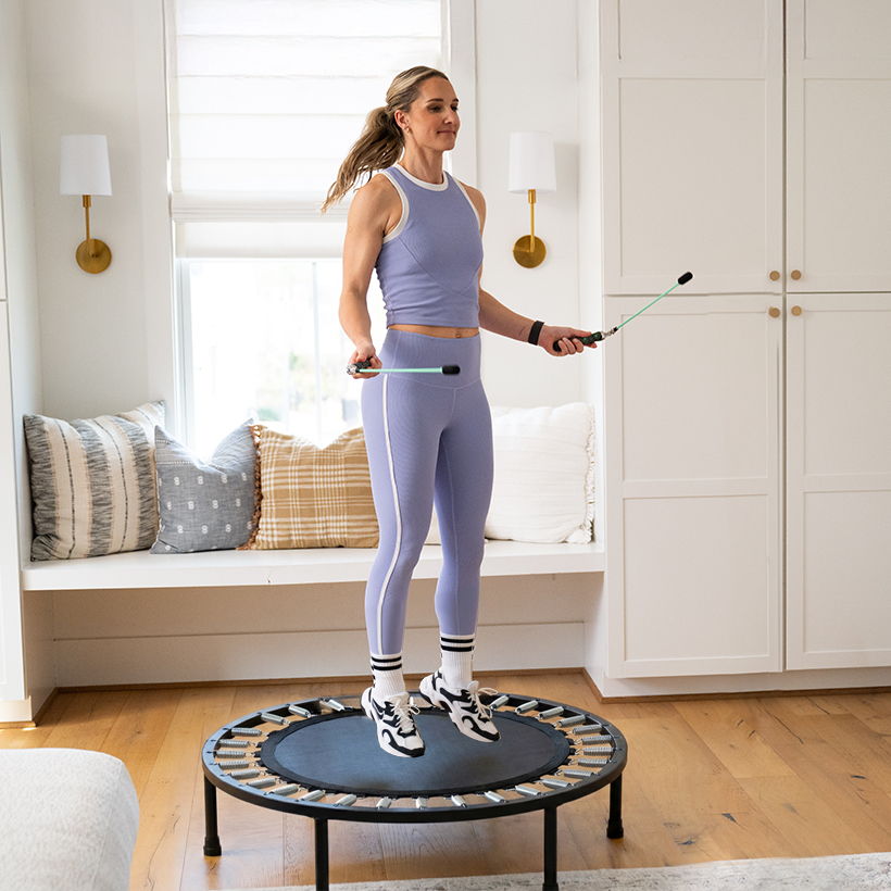 Woman jumping on a rebounder with Crossrope Ropeless jump ropes