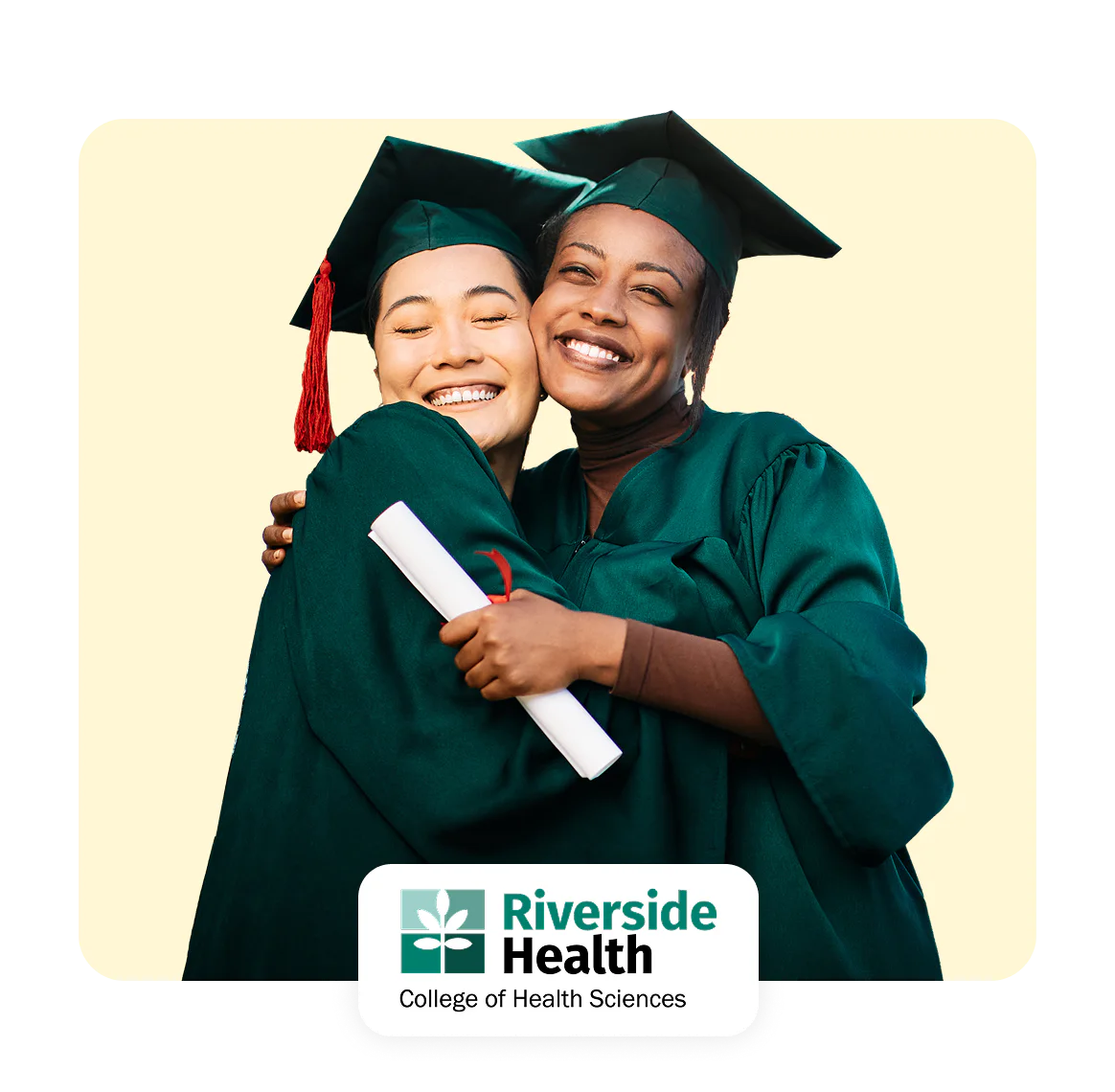 Two graduates in caps and gowns hugging, celebrating their achievement.