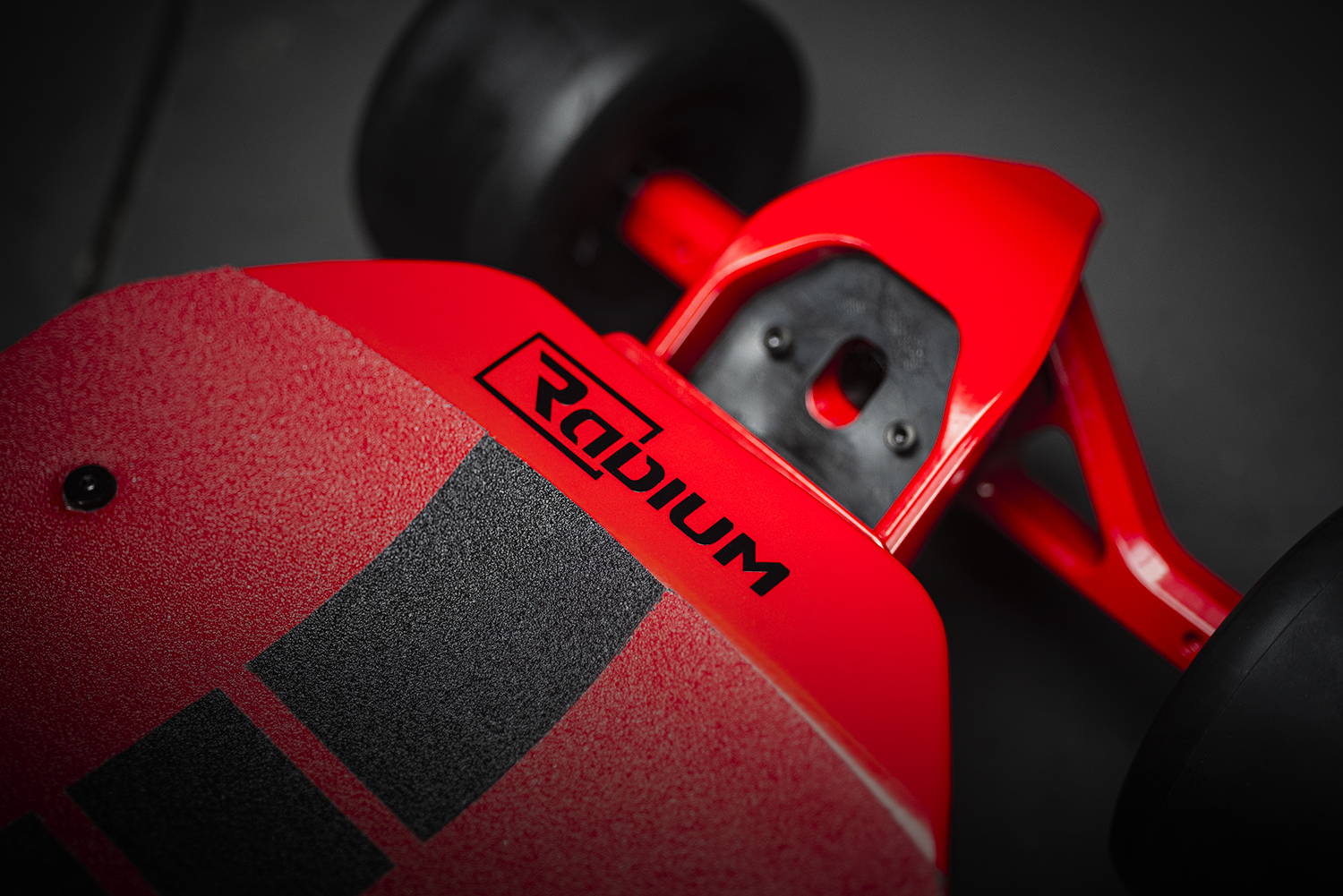 Top perspective view of trucks and wheels and deck Overall perspective view of Radium Performance Mach One XP3 Electric Skateboard