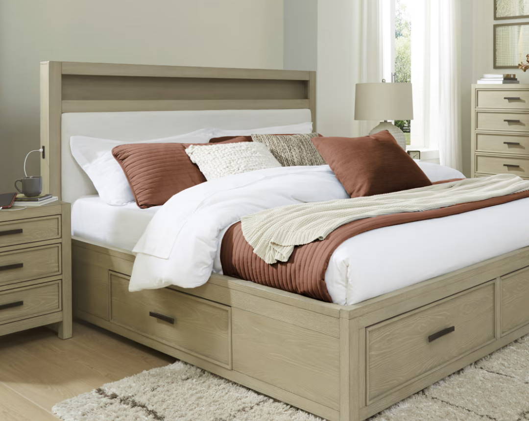 Modern bedroom with a bed, pillows, and a dresser.