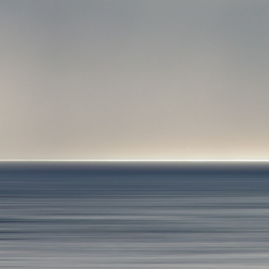 A stylized painting of the ocean at twilight