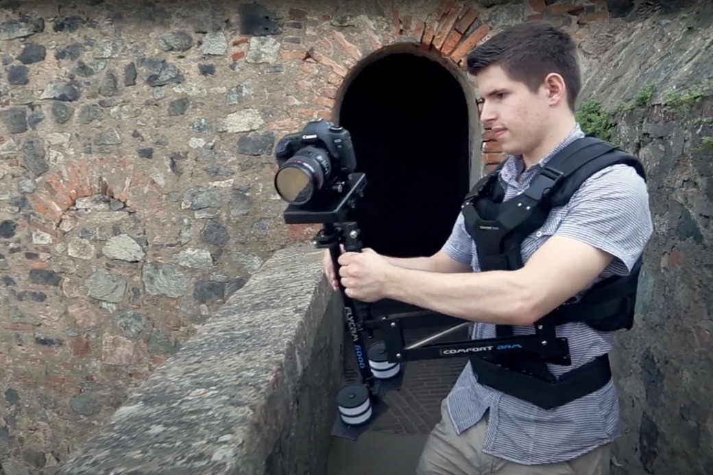 Operator filming with the Flycam 5000 system by a stone wall
