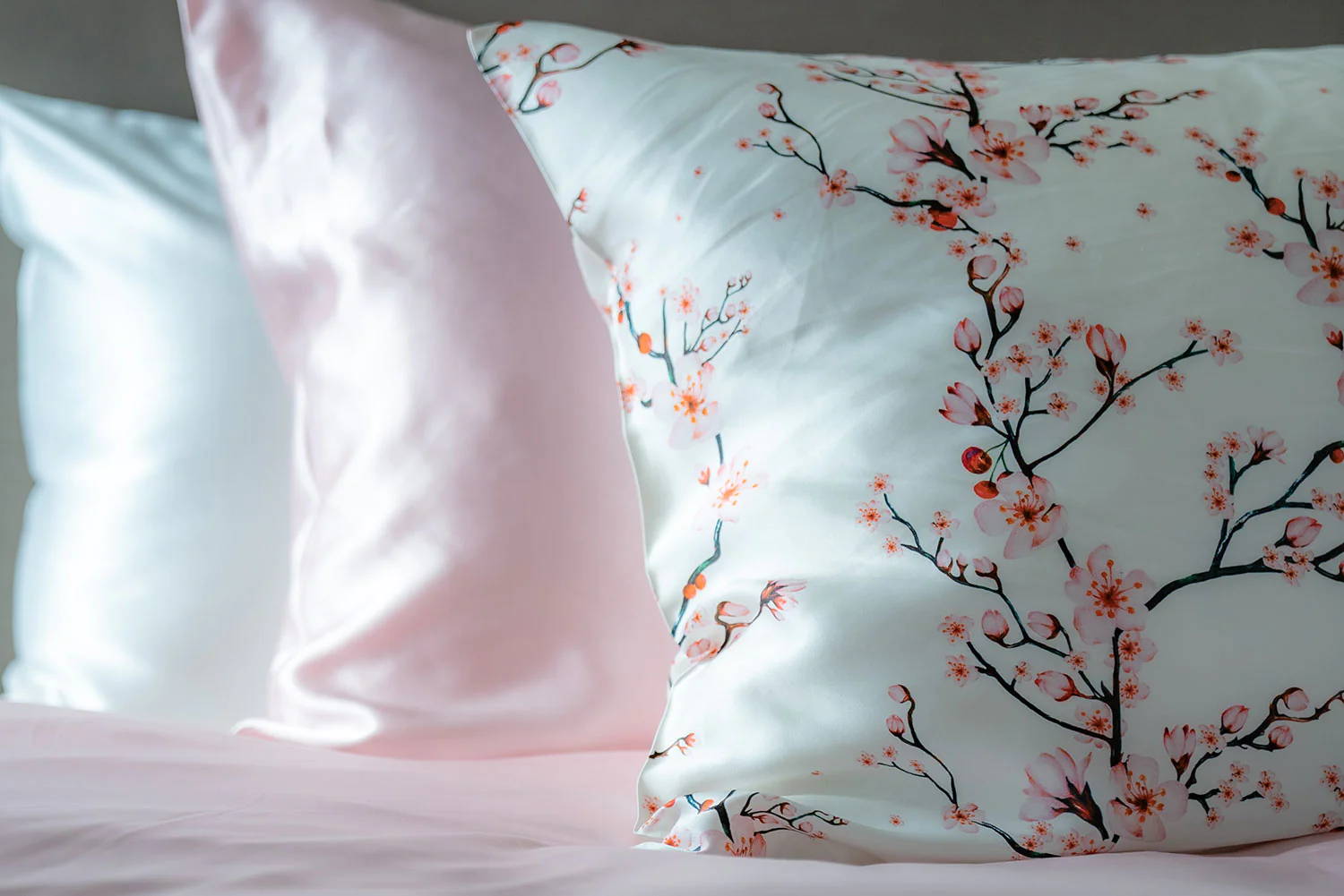 three silk pillowcases in cherry blossom print, pink and white