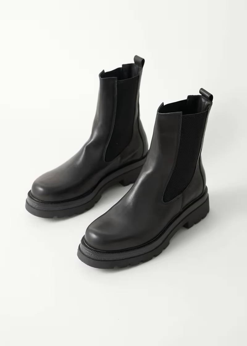 A pair of black, leather chelsea boots