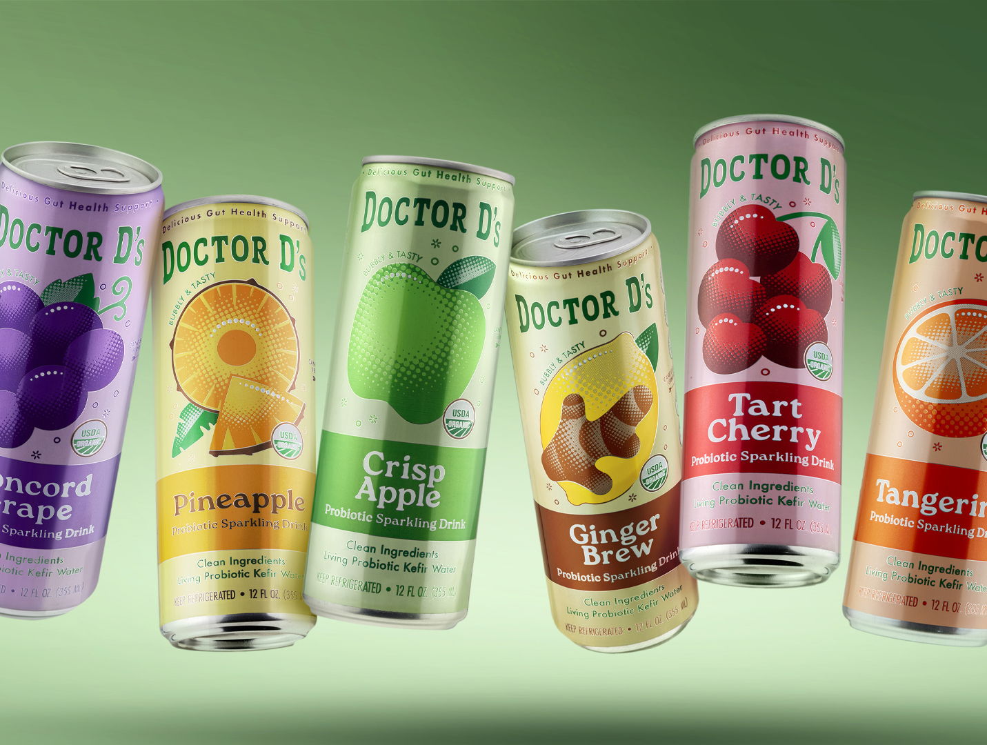 Cans of Doctor D's fruit drinks in various flavors against a green background.