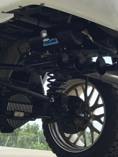 Rear suspension coil spring Bilstein shock axle housing John's 2014 Dodge Ram 2500 Shocker XL Train HornBlasters featured customer install gallery photo 5