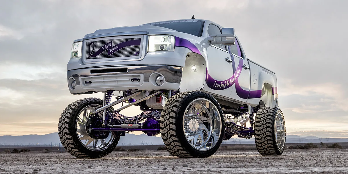 Lifted white GMC truck with purple accents front exterior view
