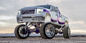 Lifted white GMC truck with purple accents front exterior view