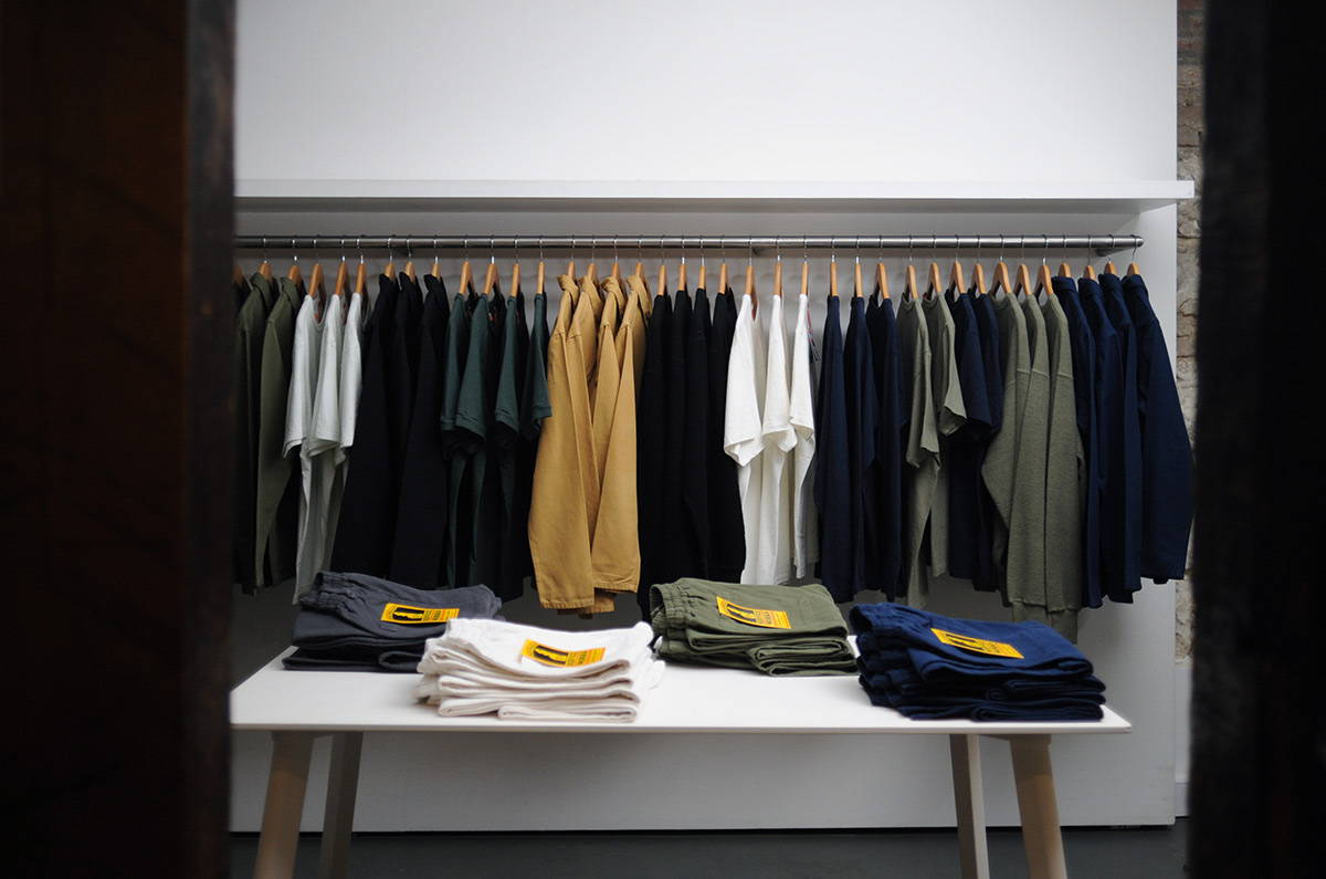 A styled image of Service Works Chef Trousers and Coverall Jackets on display in the Basement.