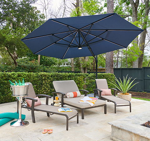 Outdoor seating area with lounge chairs and a large umbrella.