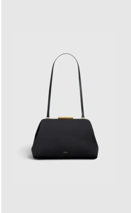 Black handbag with a long strap and gold clasp.