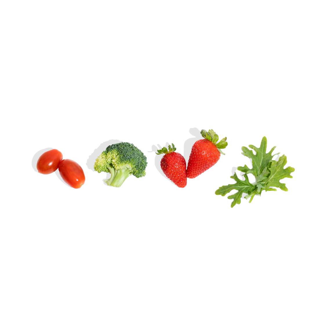 flat lay of fruits and veggies, containing tomatoes, broccoli, strawberries, and greens
