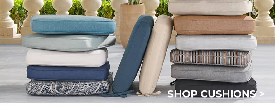 Cushions and striped outdoor rugs displayed for shopping.