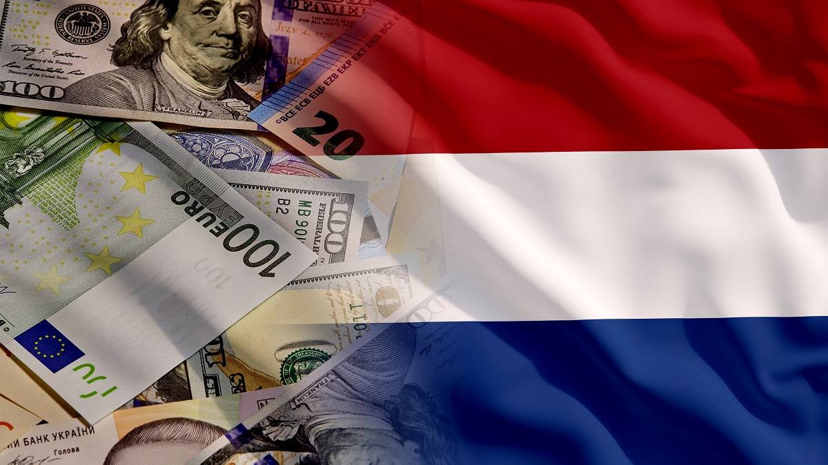 Different types of currency next to the flag of the Netherlands