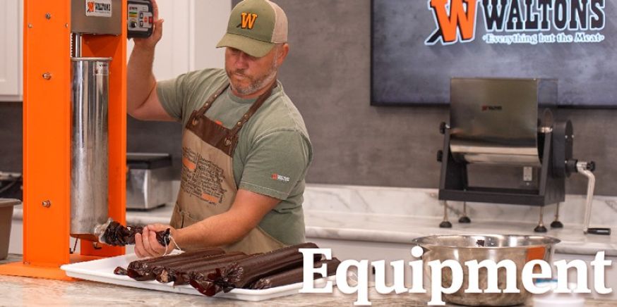 Person using equipment in a kitchen setting with a logo in the background.