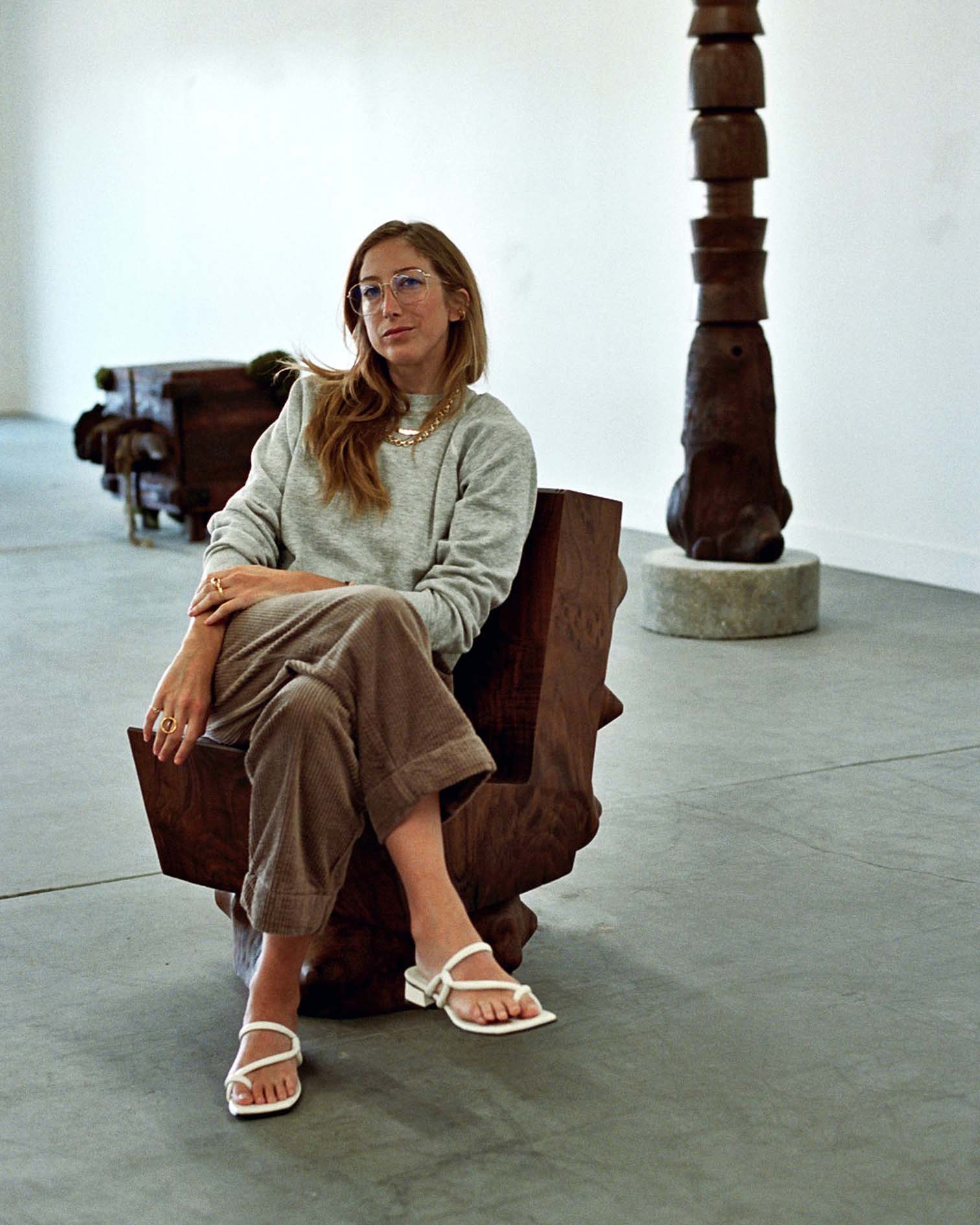 An image of Kyle Dewoody sitting on a chair as part of her show, Totum.