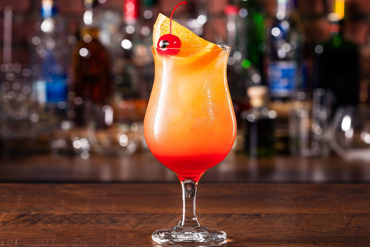 Island Jay's Hurricane Drink Recipe make with a mix of white & dark rums and fresh juices service in a hurricane glass