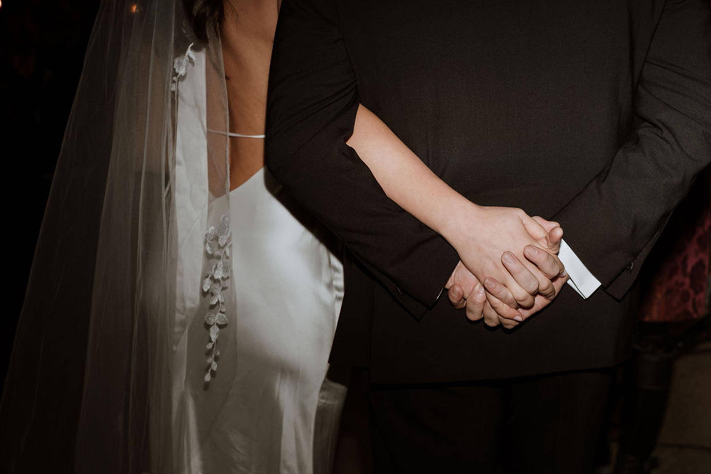 Bride and groom holding hands