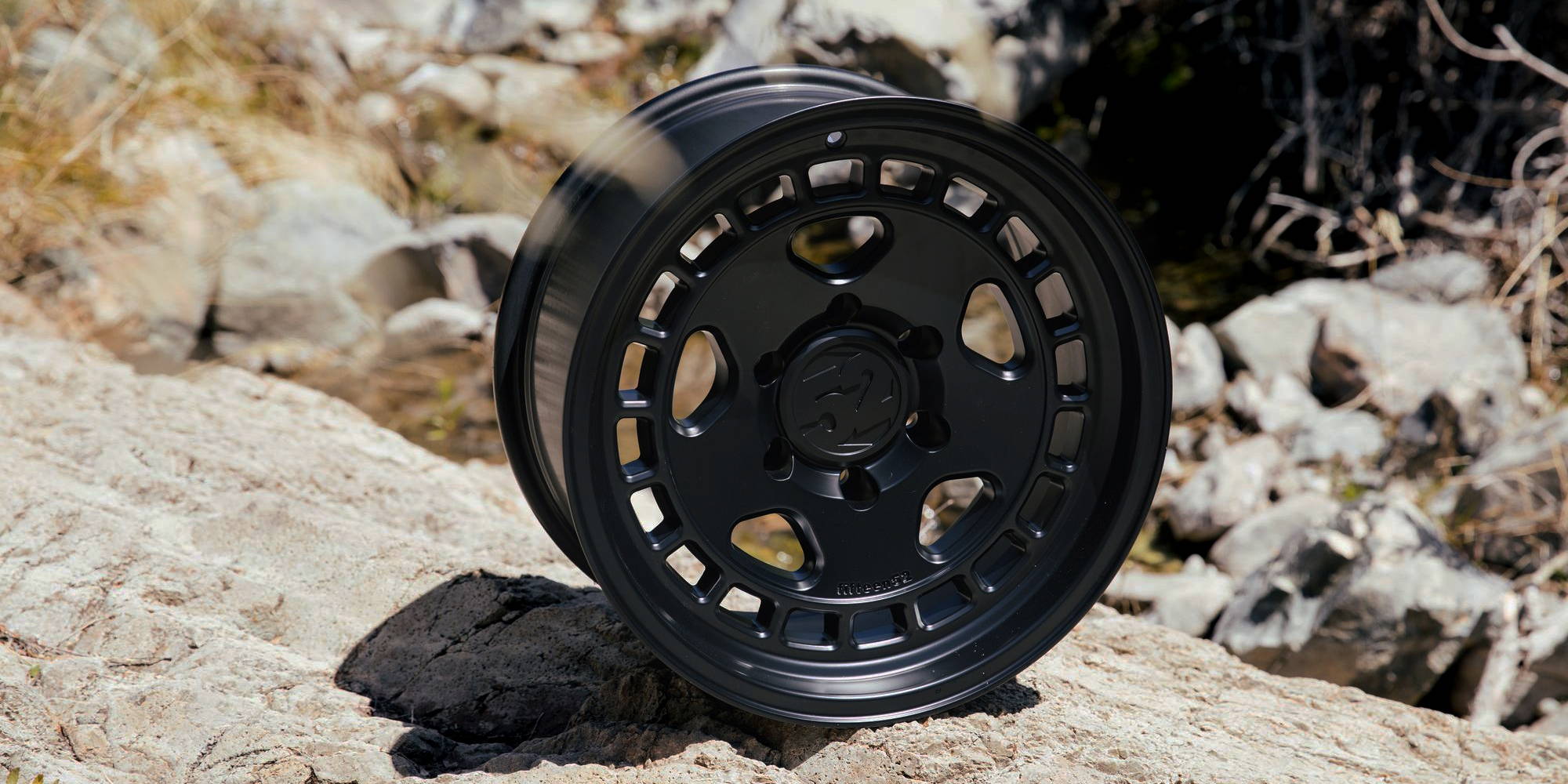 Black fifteen52 Turbomac HD Classic wheel on rocky terrain