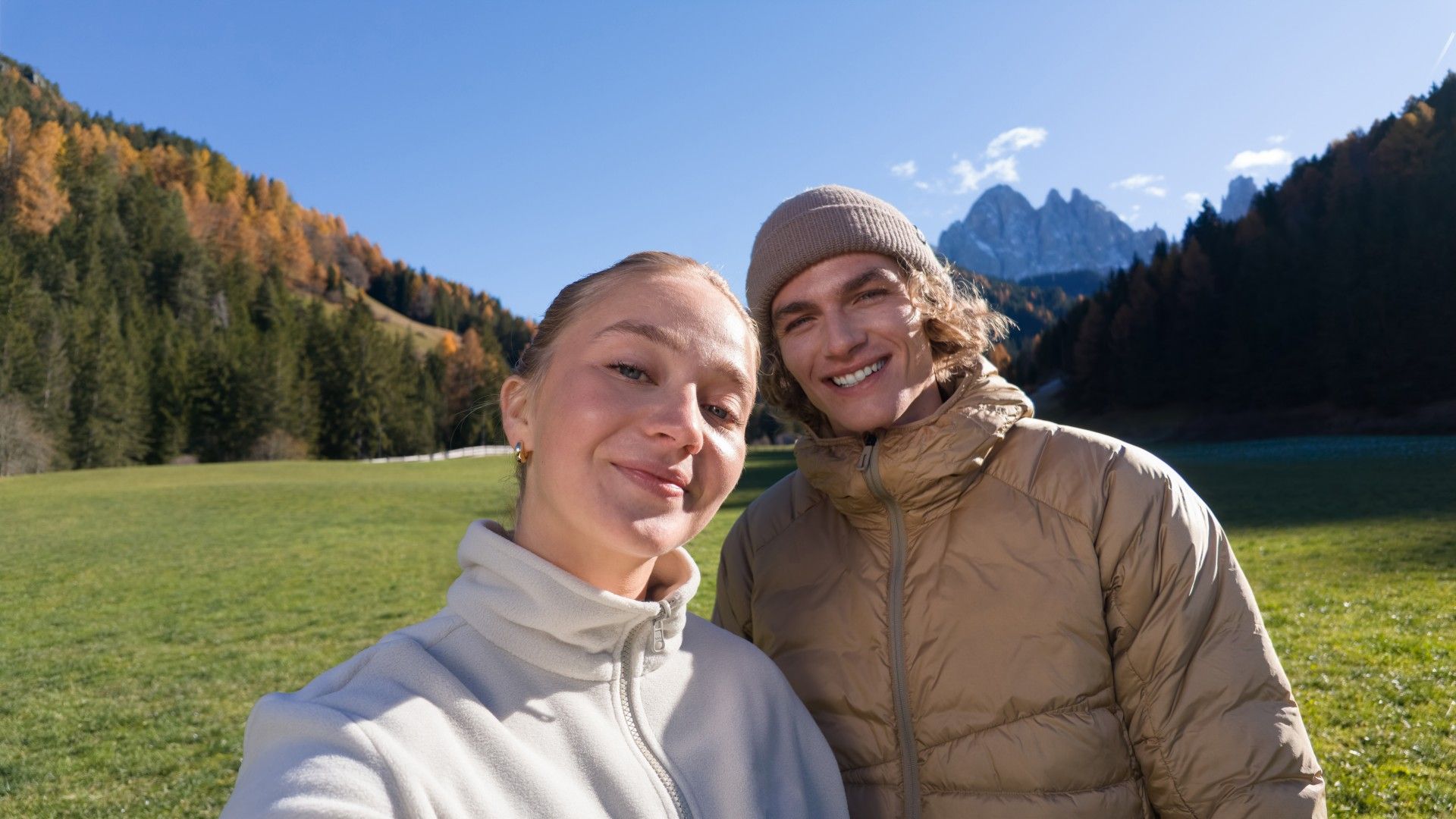A couple taking a selfie in a scenic outdoor setting.