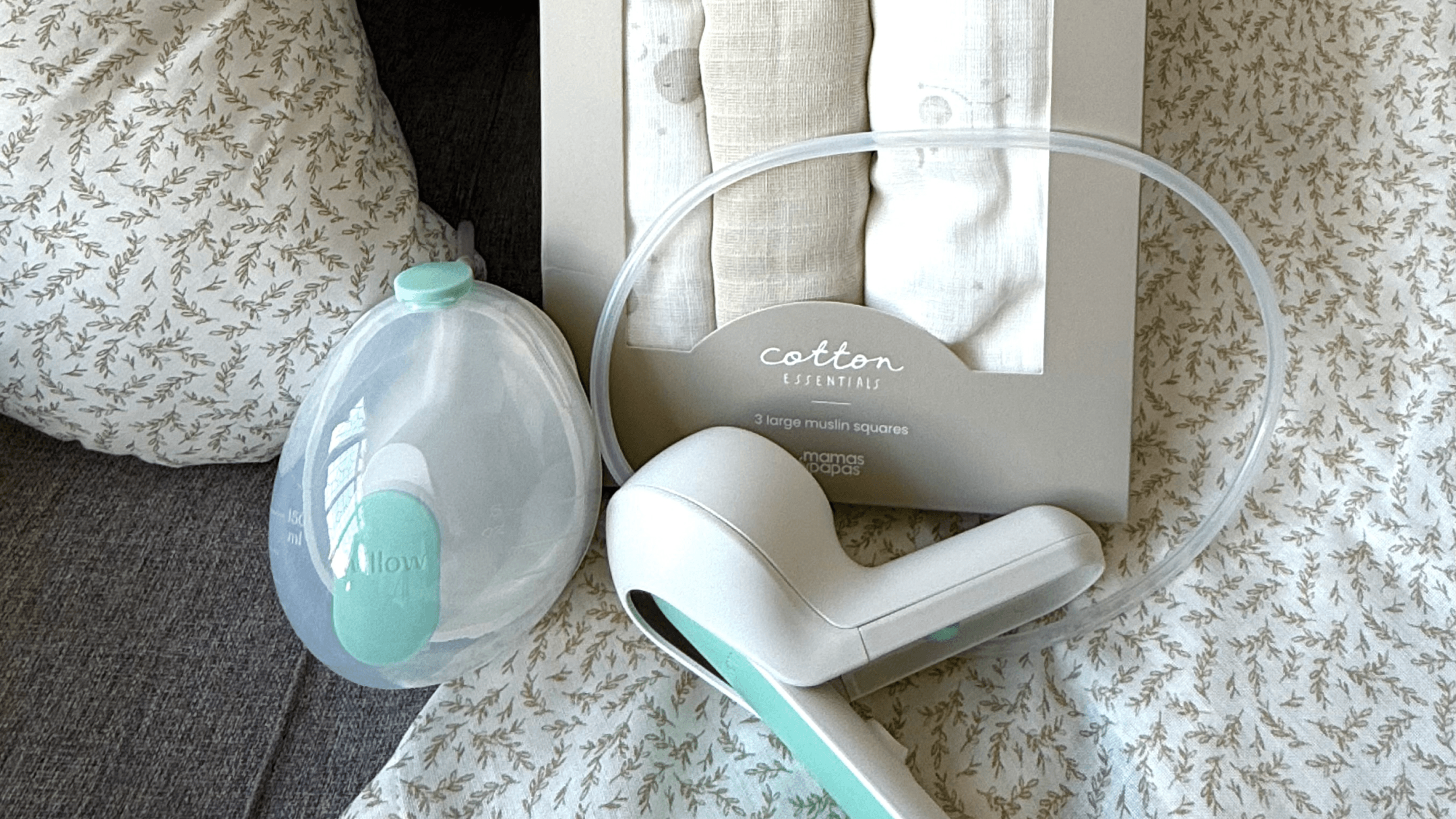 Breast pump kit with accessories on a textured blanket.