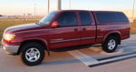 Maroon first-generation Toyota Tundra Access Cab with color-matched camper shell black side steps chrome bumper and alloy wheels parked on asphalt at golden hour Dennis's Nathan Airchime K5 train horn featured customer install gallery photo 1