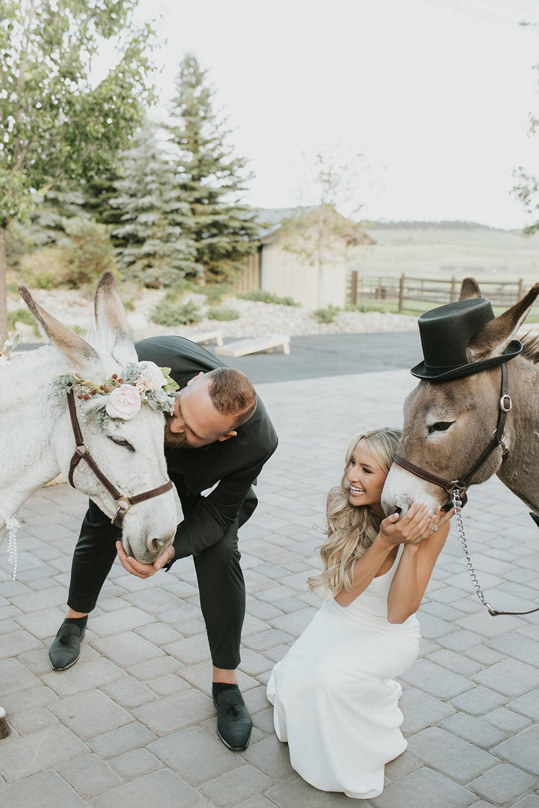 Bride and groom, blissfully cuddling their pony, radiate pure happiness.