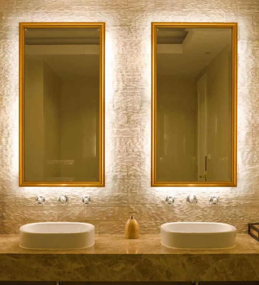 Double sink bathroom with backlit mirrors using LED strip lights