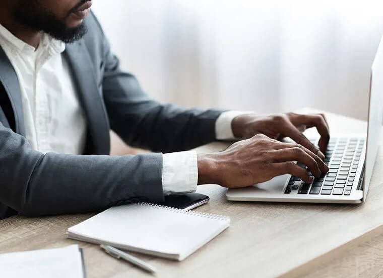 Man typing on a laptop