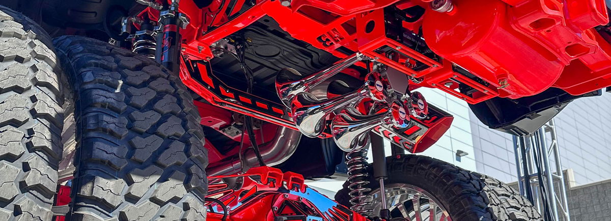 Burgundy undercarriage train horn install on a Ford F-150