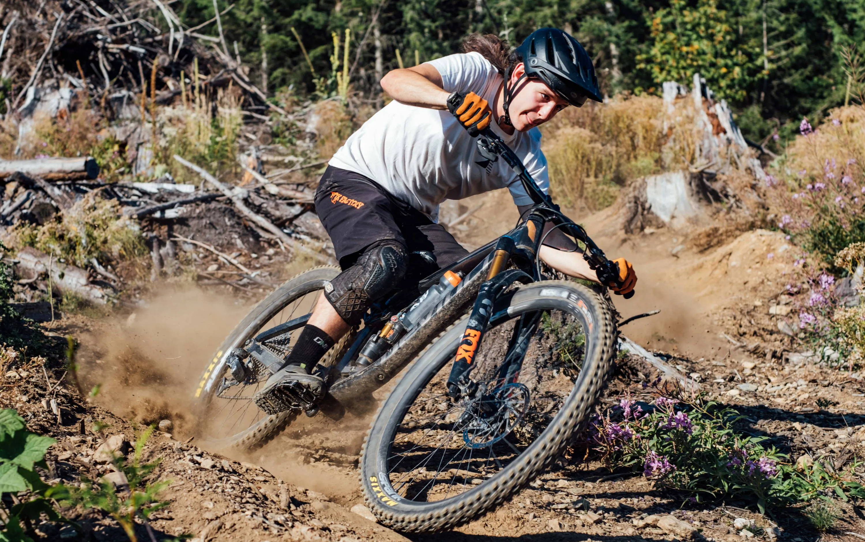 mike ripping a dusty corner with a maxxis assegai and maxxis dissector