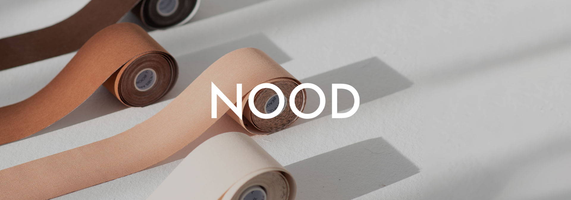 Nood solution underwear brand image with tape product in the background.