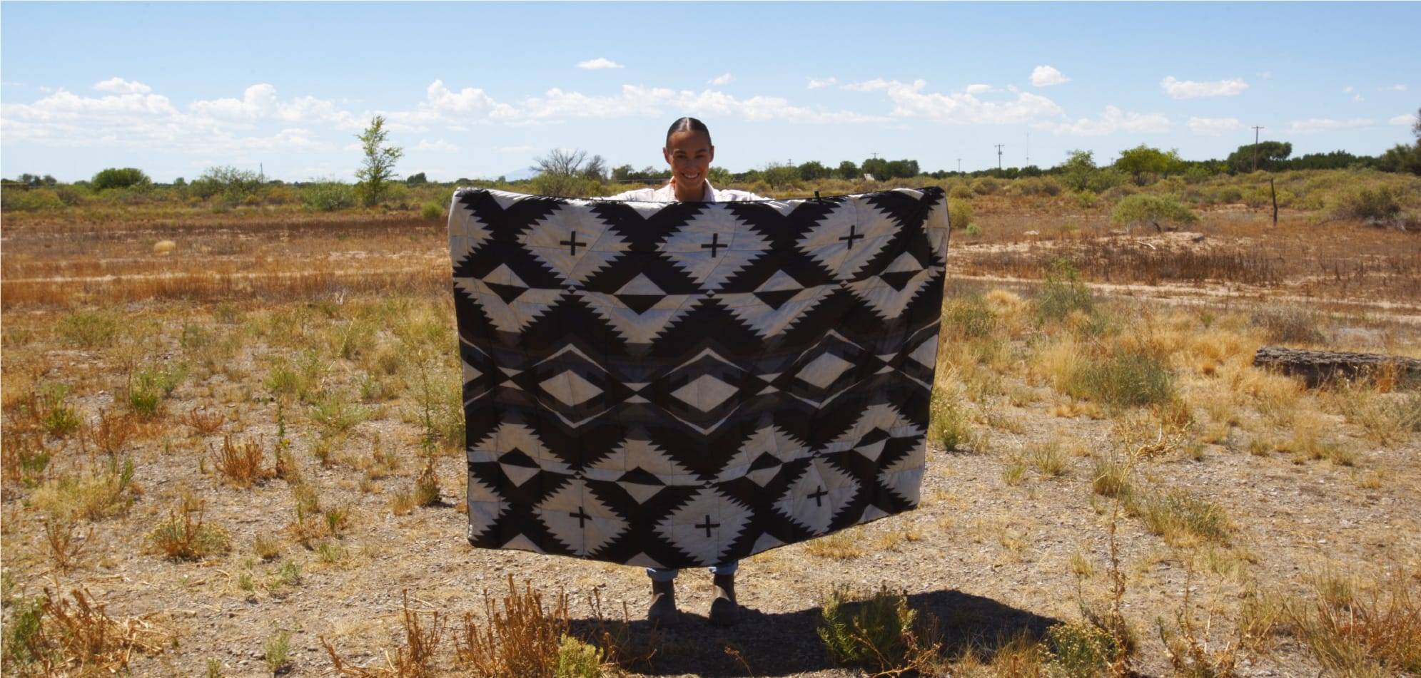 Jordan Craig holding her Woven Daydream native blanket