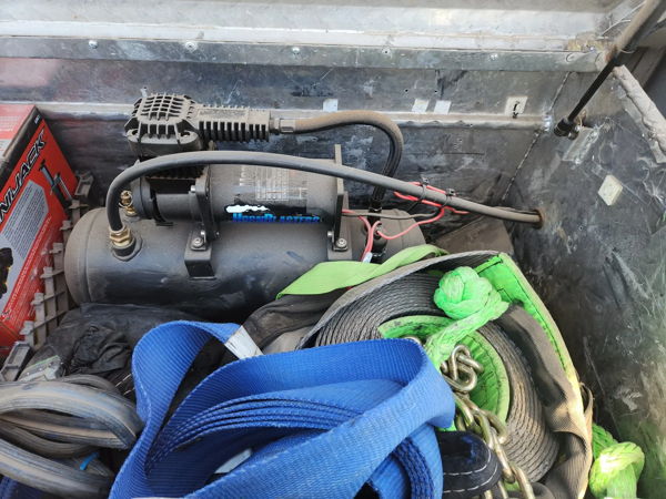 HornBlasters air compressor and tank installed inside truck bed toolbox with recovery gear