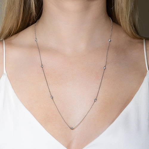 Woman wearing a lab grown diamond accented necklace by MiaDonna