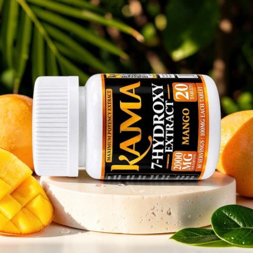 Kama 7-Hydroxy Extract bottle with mango on a light surface and greenery.