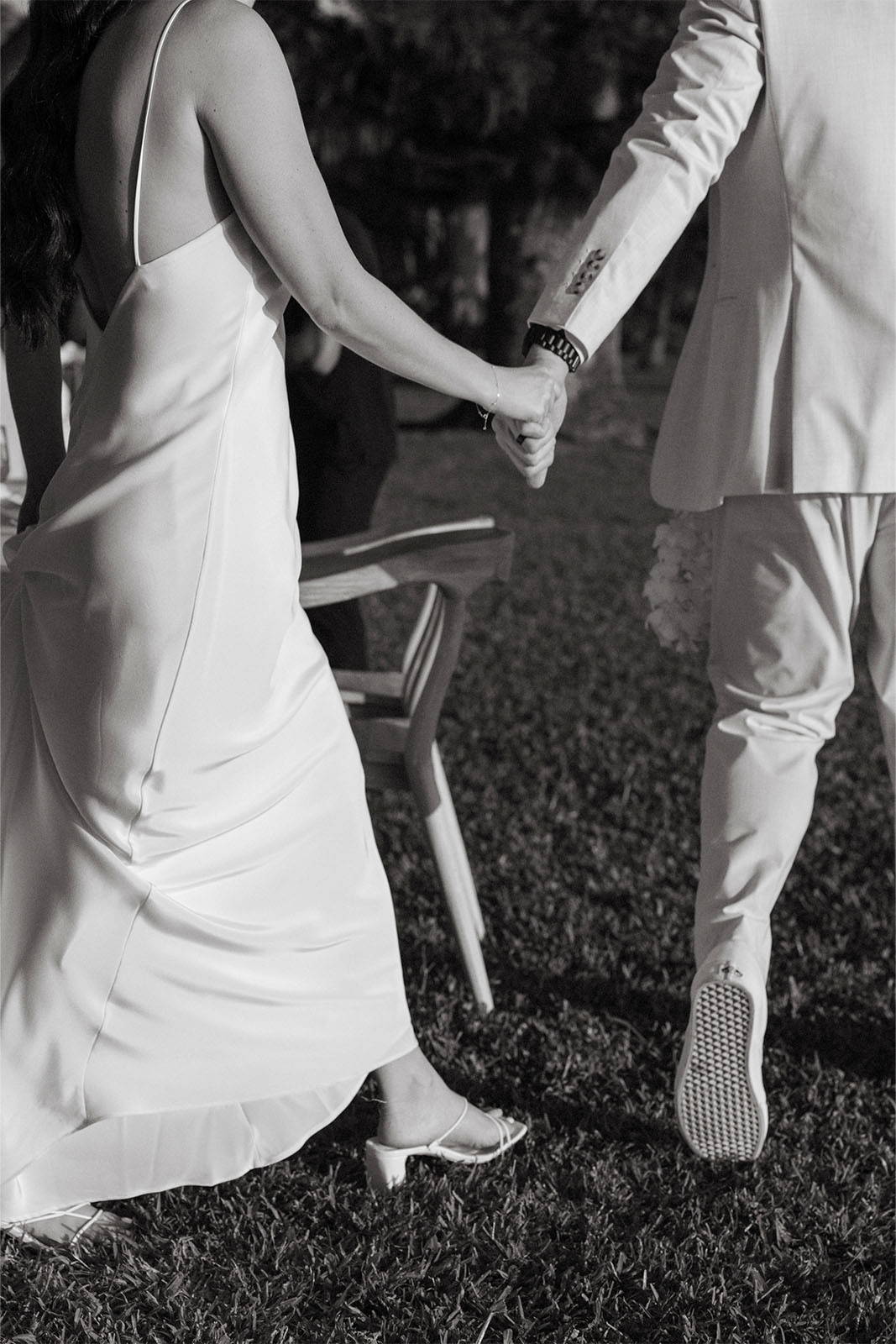 Bride and groom holding hands