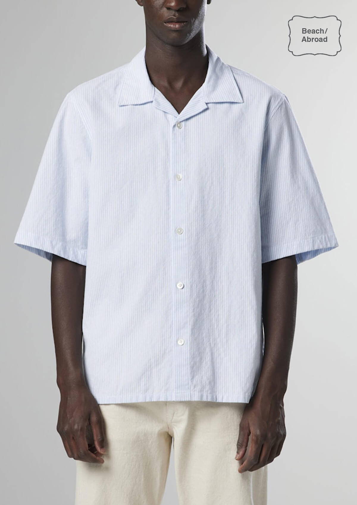 A look book image of a model wearing the NN07 Ole Short Sleeve Shirt in blue stripe.