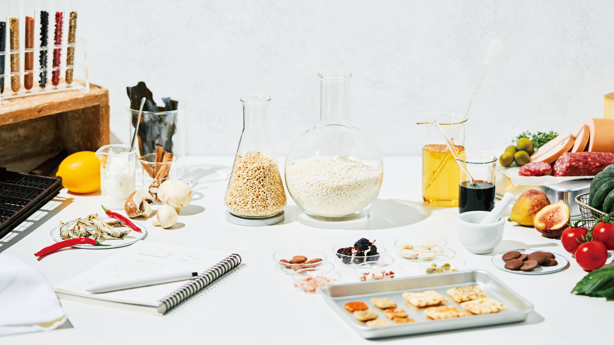 Assorted ingredients and kitchen tools arranged on a white surface.