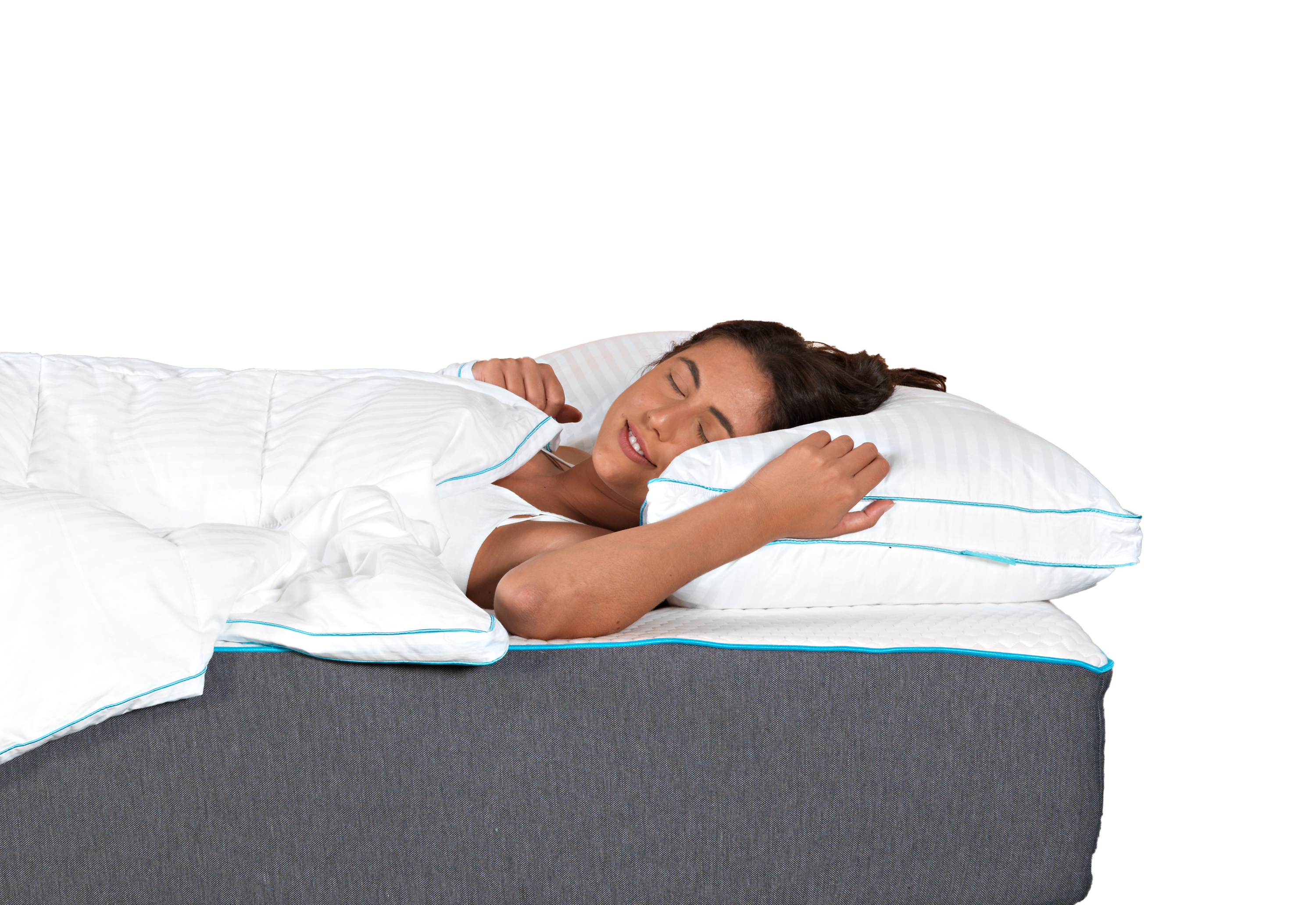 A woman laying on a Zeek Mattress snuggling up to a Zeek Cloud Pillow.