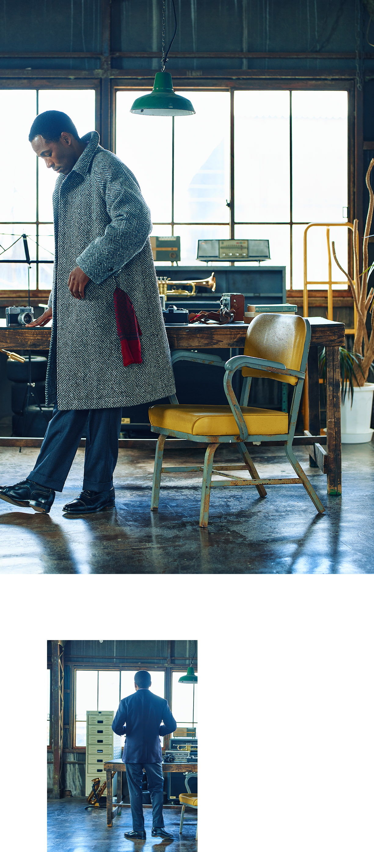 A man in a coat walking past a chair in a workshop.
