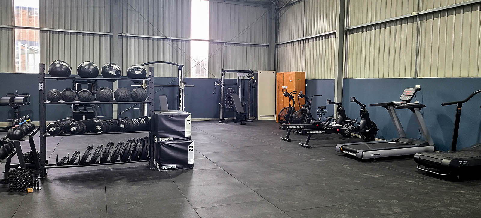 High School Gym Fit Out at Monaro School featuring a diverse range of cardio machines and free weights in a spacious, well-lit area.