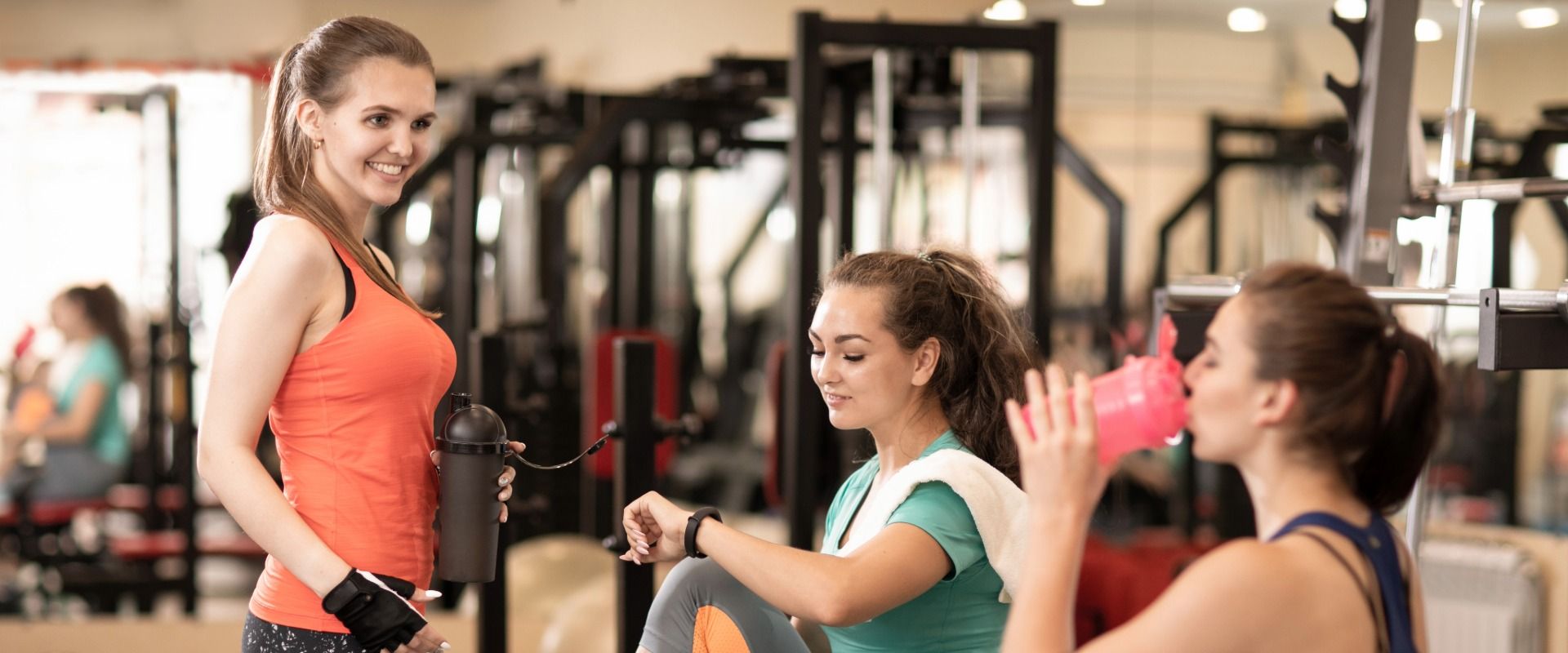 Three woman working out and drinking water