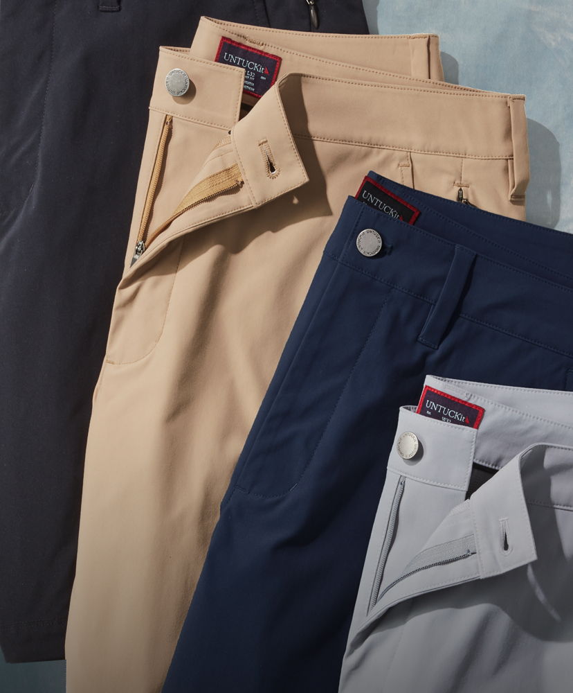 Four pairs of folded pants in various colors.