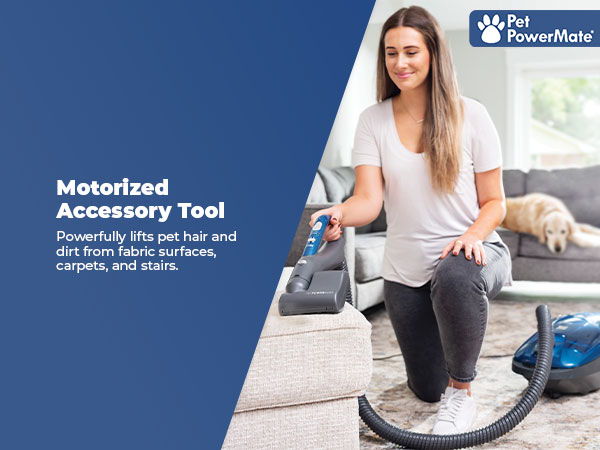 Woman using a vacuum with a motorized accessory tool for pet hair removal.