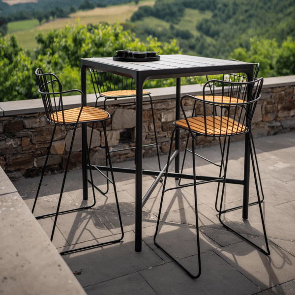 Outdoor stools around a tall patio table, adding flexible seating for a backyard layout designed for hosting guests. 