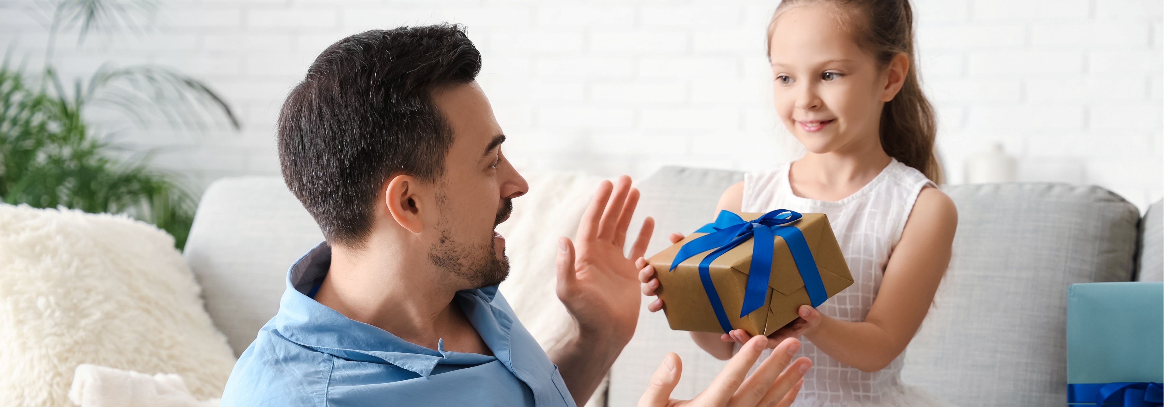 A child giving a gift to a surprised adult.