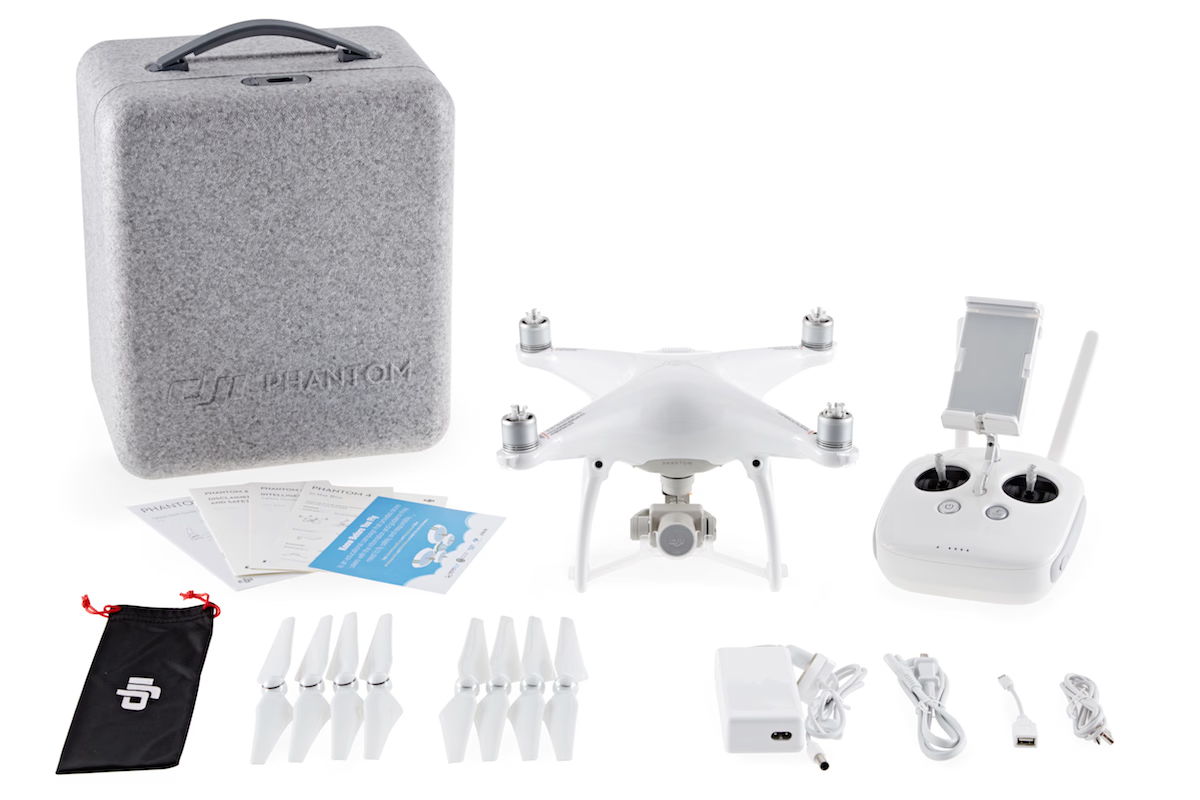 A Phantom 4 kit with accessories, including remote, charger, and spare propellers.
