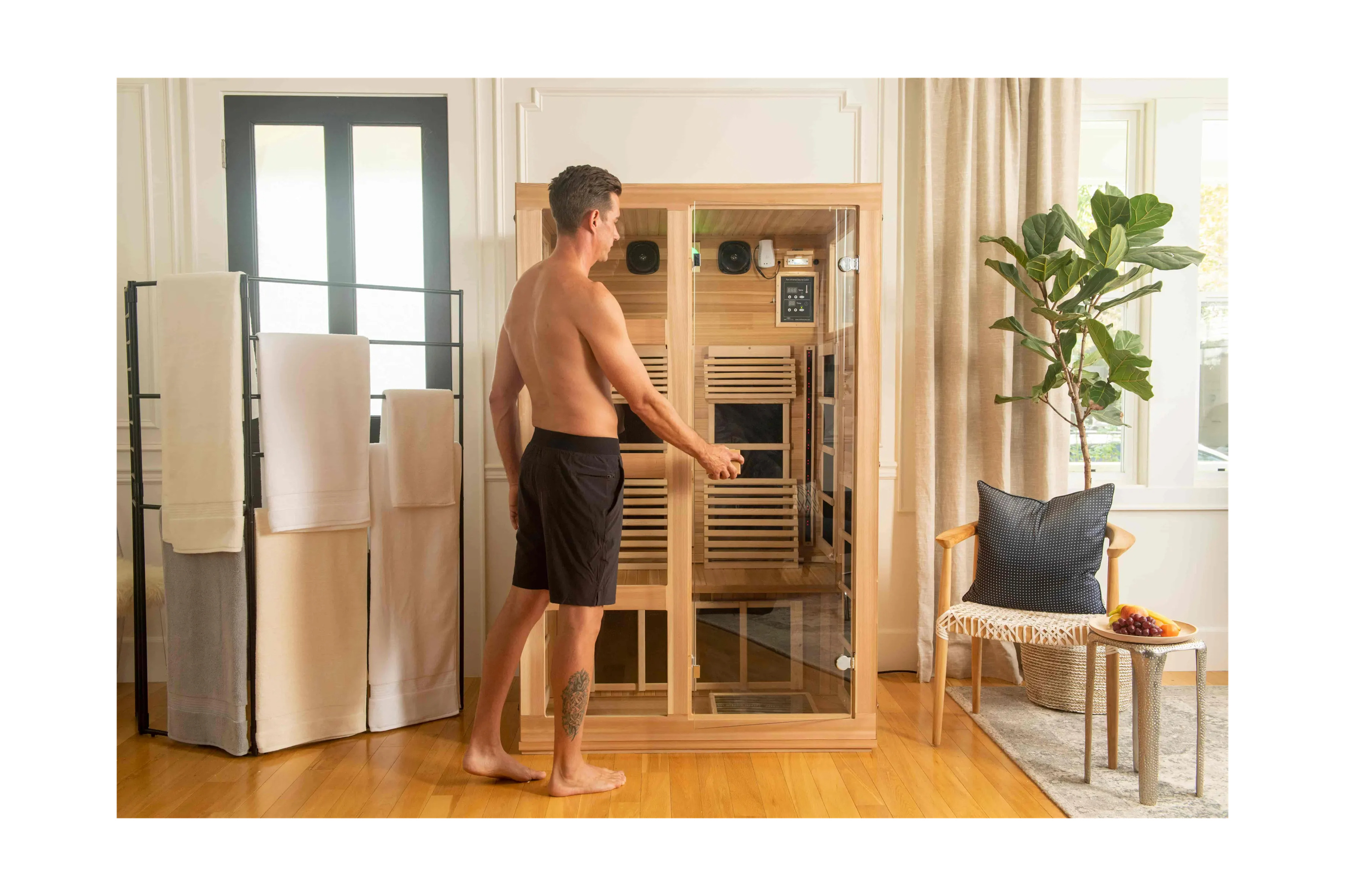 man stepping into a full spectrum infrared sauna by JNH Lifestyles
