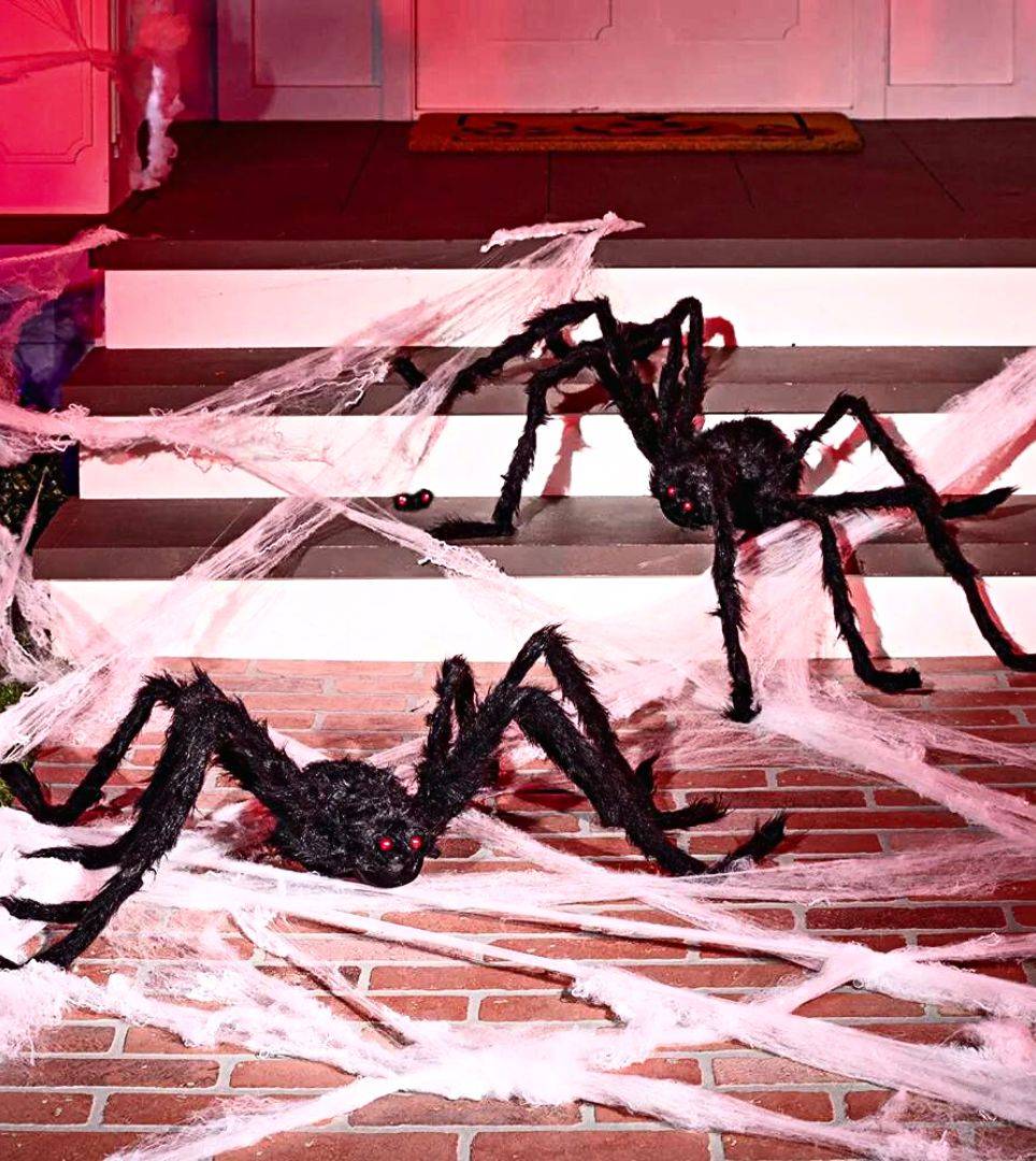 Two large black fuzzy spiders on webbing. Shop all Spiders and Webs halloween decorations.